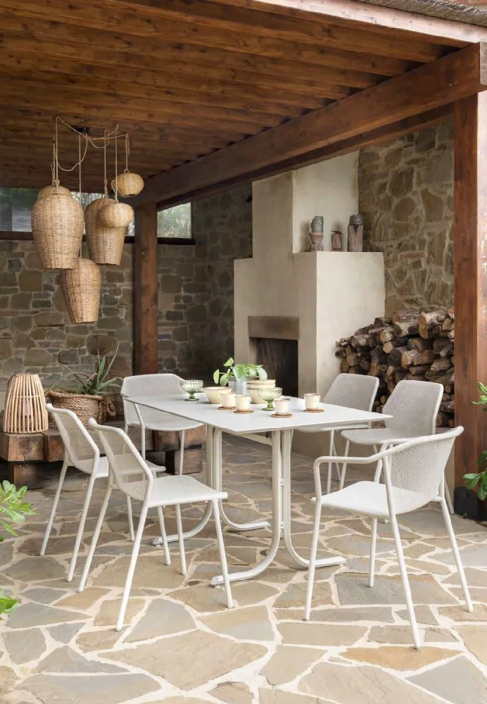 Emu DARWIN stackable outdoor chair - placed under a domestic portico with a table, white